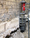 A completed installation of foundation push piers lifting a foundation in Gallatin