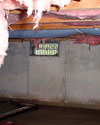 Tennessee, Kentucky, and Alabama crawl space with vents, showing mold, rot, and fiberglass insulation dripping off the ceiling.