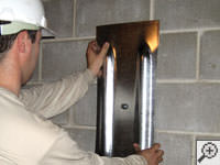 Mounting a foundation wall plate for an earth anchor installation in Hendersonville.