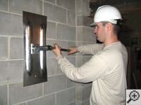 Attempting to straighten a bowed foundation wall by straightening a wall anchor system in a Smyrna home.