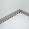 A partition wall separating from the floor in a Manchester home.