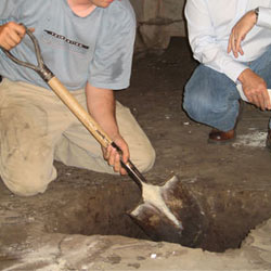 Digging a hole for the engineered fill used in a crawl space support system installation in Bowling Green