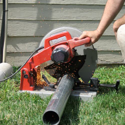Cutting the support beam for a crawl space jack post outside a Smyrna home.