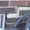 A closeup of a failed tuckpointing job where the brick cracked on a Mayfield home.