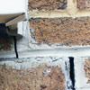Failed crack repair showing old tuckpointing that cracked on a Jackson home.