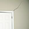 A long drywall crack beginning at the corner of a doorway in a Madison home.