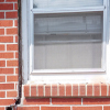 A gap in a window along the outer wall due to foundation settlement of a Paducah home.