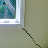 A long, diagonal crack that begins at a window corner of a Brentwood home