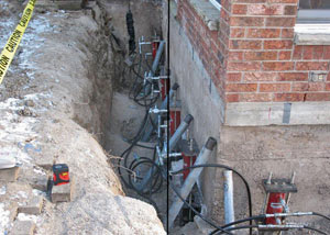 Foundation push piers installed around a house with a foundation settlement issues in Springfield