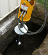 Installing a helical pier during a foundation repair in Huntsville