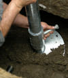 Huntsville helical pier installation nearing completion, with the blade being advanced into the foundation soils.