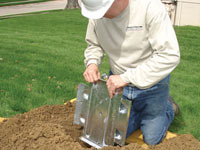 Fastening an earth anchor for a severely bowing wall in Athens.