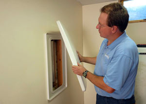 Foundation wall anchor covers installed in a finished basement with a repaired foundation wall in Murray.