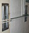 Foundation wall anchor plates installed in a basement in Jackson