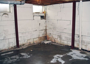 A failed, rusty i-beam foundation wall system installed in Springfield.