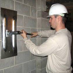 installing a wall anchor to repair an bowing foundation wall in Shelbyville