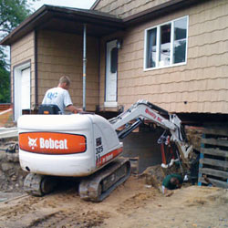 Excavating to expose the foundation walls and footings for a replacement job in Columbia