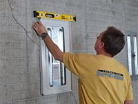 Positioning a wall plate cover on a foundation wall in Bowling Green.