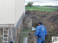 Drilling the hole in the foundation wall for street creep repairs in Madison