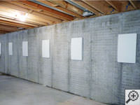 Wall anchor covers installed along a foundation wall that has been straightened in .
