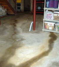 Flooding entering a basement through a floor crack in Manchester