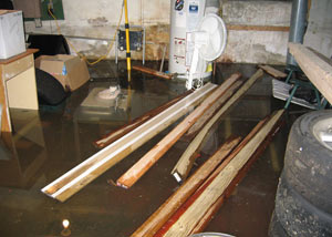 A severely flooding basement in Smyrna, with lumber and personal items floating in a foot of water