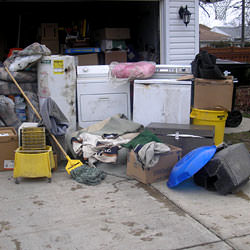 Soaked, wet personal items sitting in a driveway, including a washer and dryer in Bowling Green.