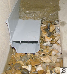 A no-clog basement french drain system installed in Athens